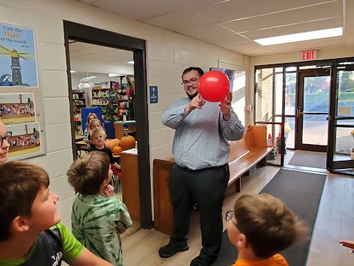 Teacher holding a balloon during a science lesson