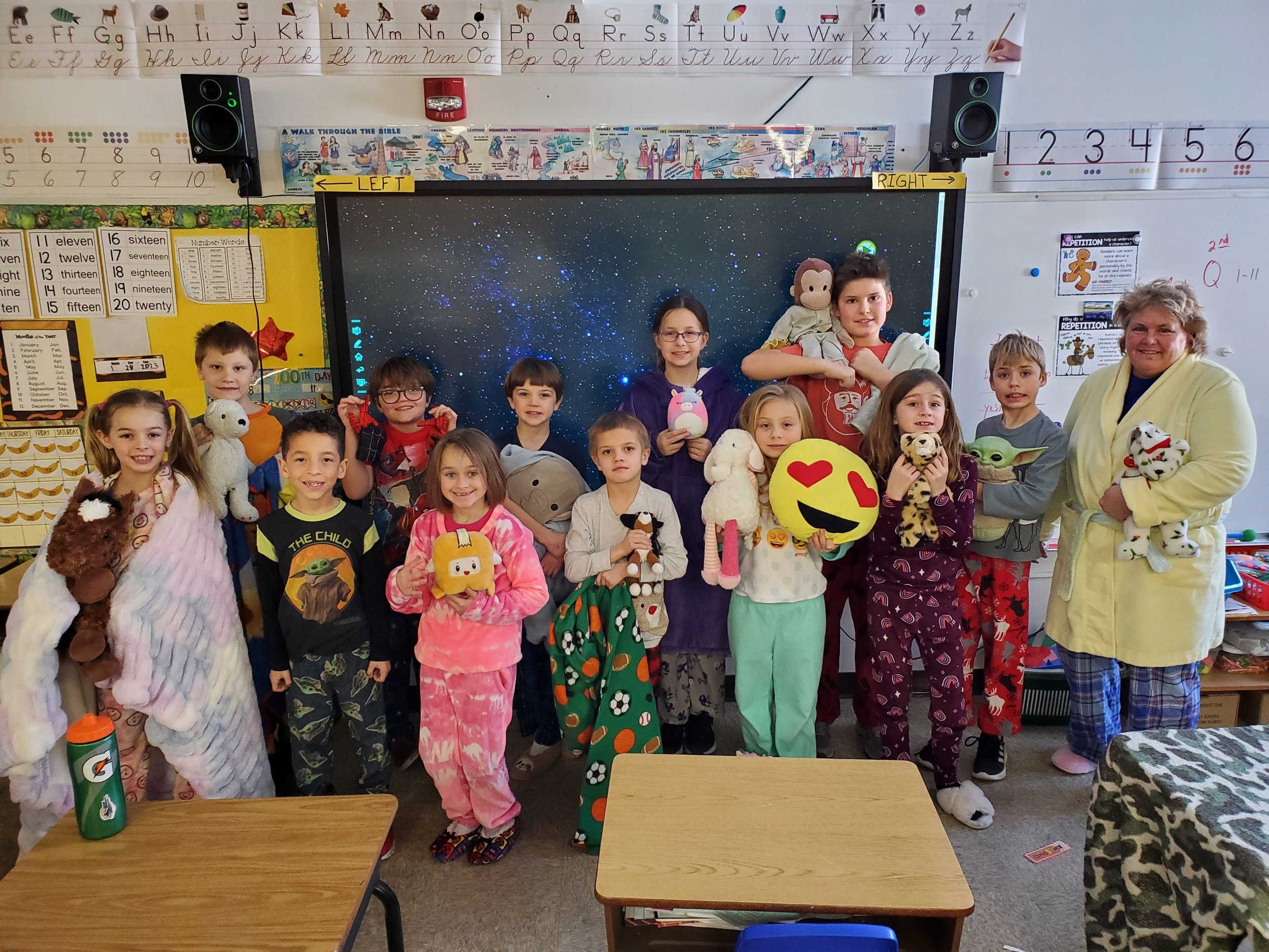 Students and their teacher in pajamas with stuffed animals