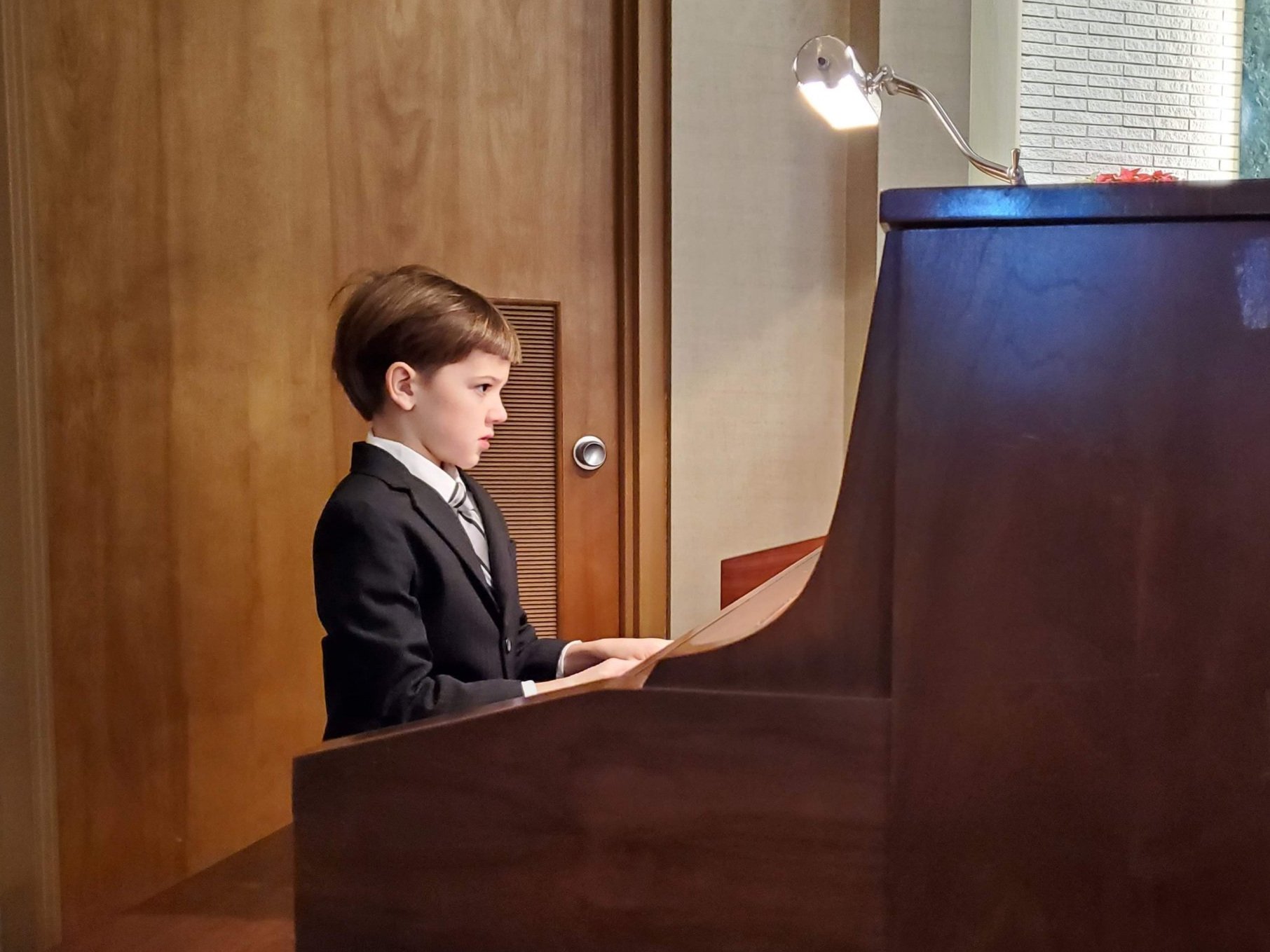 Student playing the piano in church